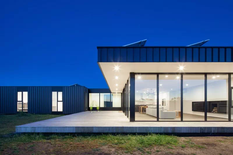 Modern modular home at dusk with lights on