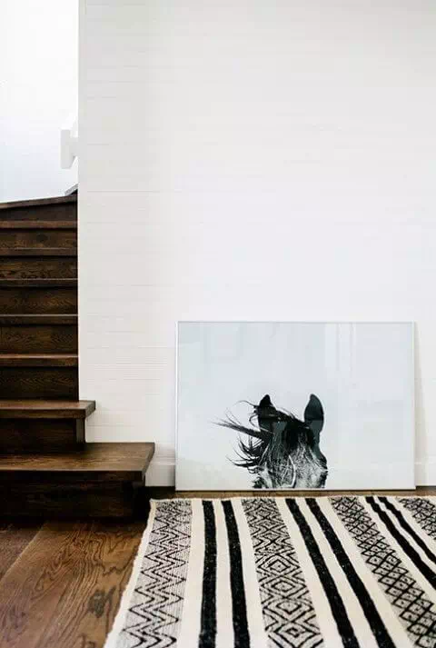 Leaning artwork beside a staircase in your modular home