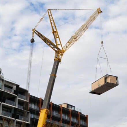 Modular home being installed by crane in suburban Melbourne